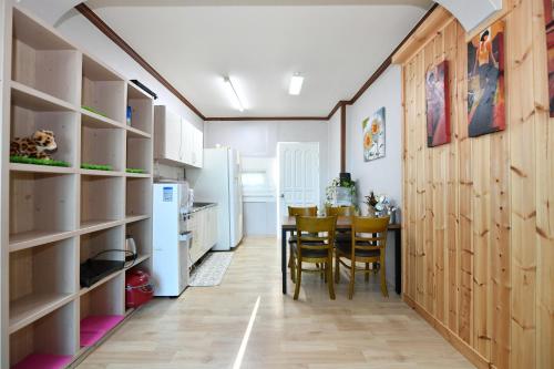 a kitchen and dining room with a table and chairs at Sokcho Daemyung Pension in Sokcho