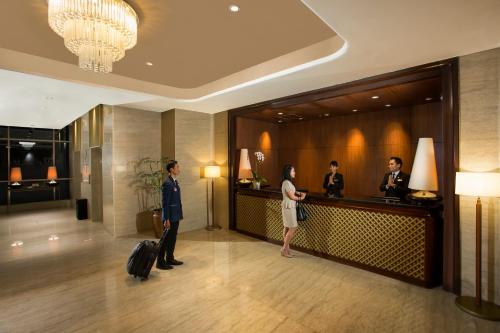 a group of people standing in a hotel lobby at Swiss-Belhotel Bogor in Bogor