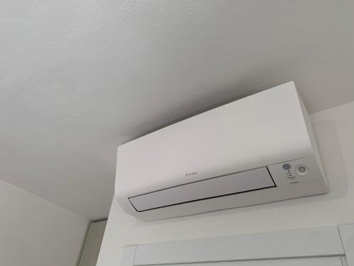 a white speaker on the ceiling of a room at B&B Somiar in San Teodoro
