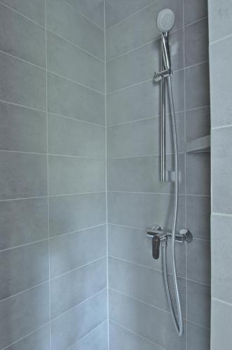 a shower with a shower head in a bathroom at Willa Morskie Oko in Gdańsk