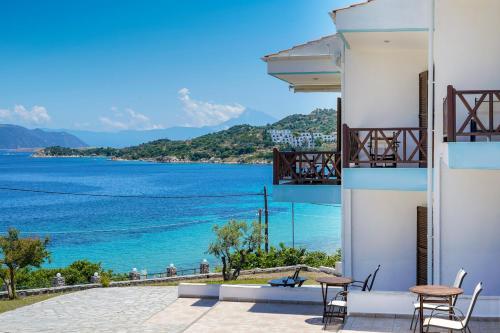 a view of the ocean from the balcony of a building at Pansion Limanaki in Ammouliani