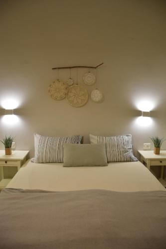 a bedroom with a large bed with two tables at Idan Lodge in the Arava in Paran