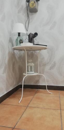 a white table with a lamp on top of it at b&b ERCOLANO Scavi in Ercolano