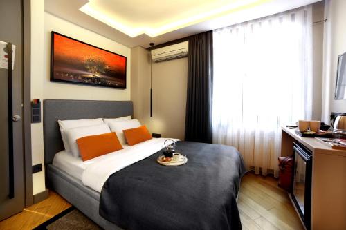 a hotel room with a bed with a plate on it at The Capital Hotel in Istanbul