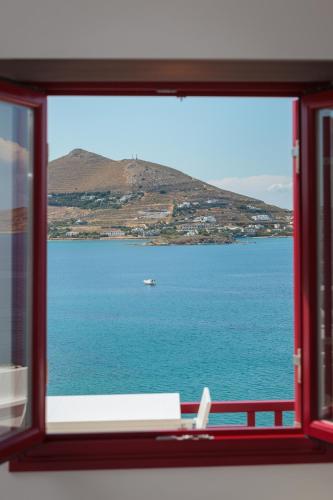 a window with a view of a body of water at Katerina mare in Naousa
