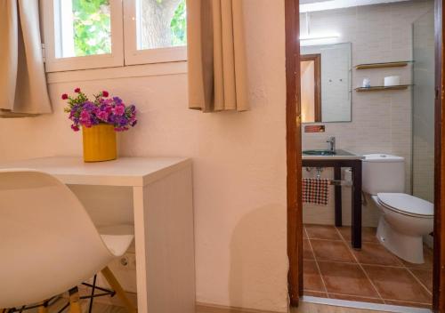 a small bathroom with a toilet and a sink at Ciudad De Vacaciones Cala Montjoi in Roses