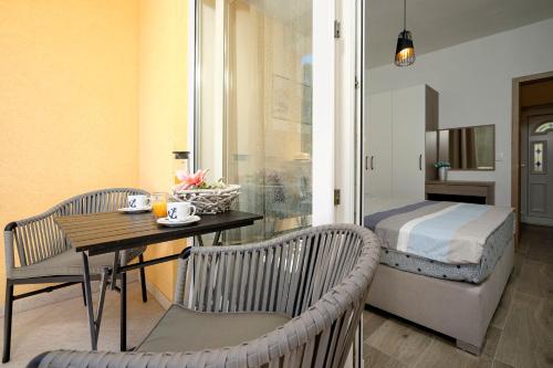 a room with a bed and a table and chairs at Villa Vista in Jelsa