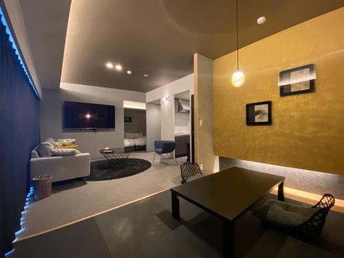 a living room with a couch and a table at Randor Residential Hotel Fukuoka Classic in Fukuoka