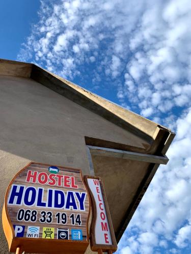 a sign for a hospital holiday on the side of a building at Hostel Holiday Cetinje in Cetinje