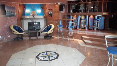 a bar with stools and a fireplace in a room at Vacation Home Seadream in Varna City