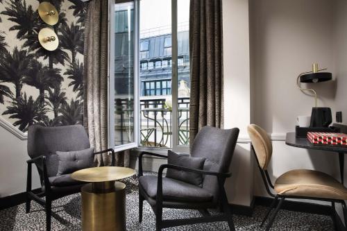 a room with chairs and a table and a window at Hôtel Gramont in Paris