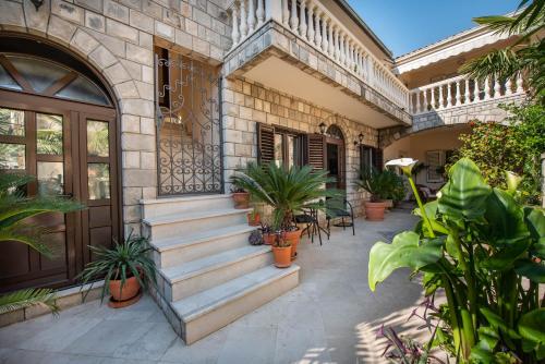 a house with stairs and potted plants on it at S&P City Center Apartments in Kotor