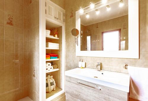 a bathroom with a sink and a mirror at Es Fasser in Alcudia