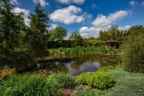a pond in a garden with a gazebo at Romala's Home 1 en 2 in Kiel