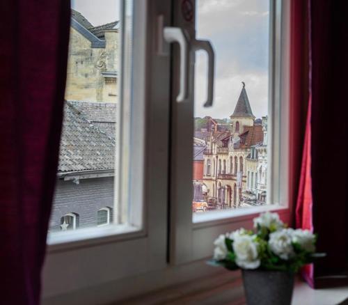a window with a view of a city at Le Bistro in Valkenburg