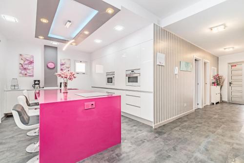 a kitchen with a pink island in a room at Sol Mogan Suites - Adults Only in Puerto de Mogán