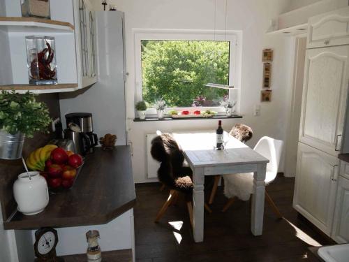 a kitchen with a table with a dog sitting at it at Nettes Lieblingsplatz in Winterberg