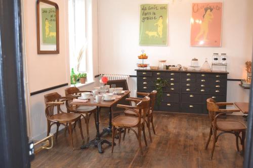 a dining room with a table and chairs at Artefact in Lamballe