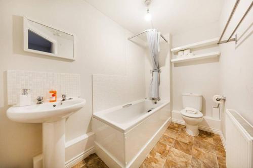 a white bathroom with a sink and a toilet at Bristol 2 Bedroom Apartment FREE PARKING in Bristol