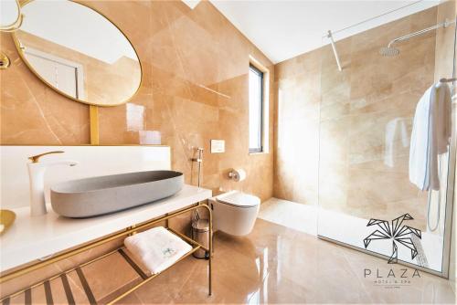 bagno con lavandino, servizi igienici e specchio di Plaza Hotel&SPA a Ulcinj