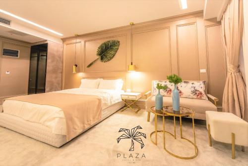 a bedroom with a large bed and a couch at Plaza Hotel&SPA in Ulcinj