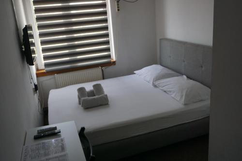 a bed in a room with a window at Guesthouse & restaurant Tekovina in Smederevo
