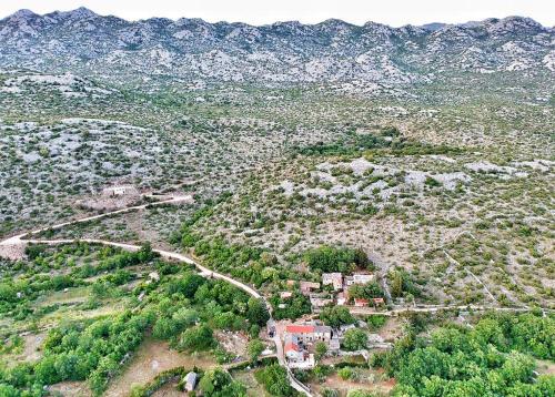 an aerial view of a town on a hill with mountains at Stone house Goranova kuća in Seline