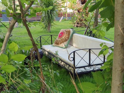 a bench sitting in the grass in a garden at Murat Pasha Mansion in Dalyan