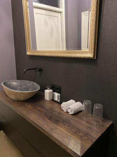 a bathroom counter with a sink and a mirror at Atalanta-Wellness Roermond 'de Archivaris' in Herten
