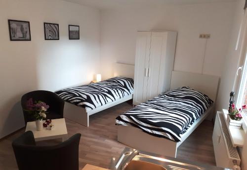two beds in a room with zebra at Ferienwohnung Wittenberge in Wittenberge