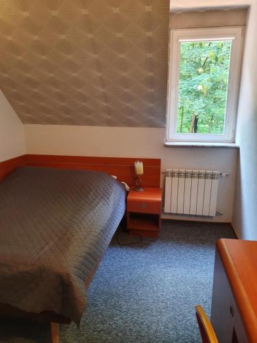a bedroom with a bed and a window at Willa Park in Ostrowiec Świętokrzyski
