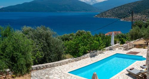 a swimming pool with a view of a lake at Villa Kandia in Ayia Evfimia