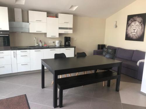 a living room with a black table and a kitchen at Jølster Holiday home in Skei 