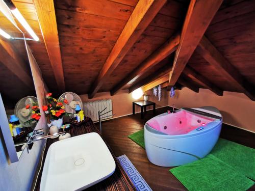 a bathroom with a bath tub in the middle of a room at Alba sul lago B&B in Stresa