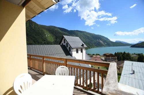a balcony with a view of a lake and a church at Residenza Alba - Molveno in Molveno