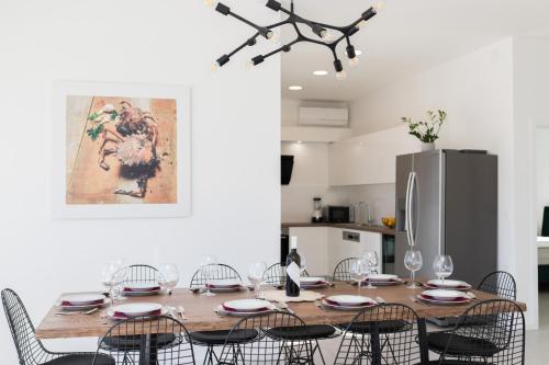 a dining room table with chairs and a refrigerator at Villa Belveder in Pag