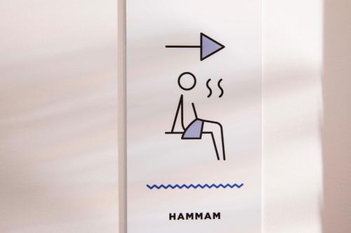 a sign that says hamman on a cell phone at Hotel Locomo - Gare de Lyon Bastille in Paris