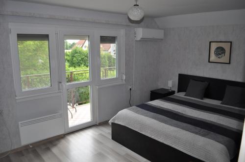 A bed or beds in a room at ZÁMOR HOLIDAY HOUSE
