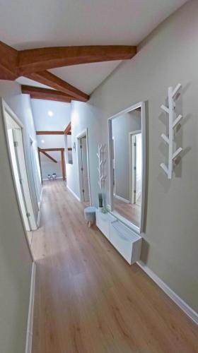 an empty room with white walls and wooden ceilings at MiTRa Luxury Apartments in Shumen