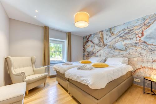 a bedroom with a large bed and a wall mural at Le Domaine de Wisbeley in Halet
