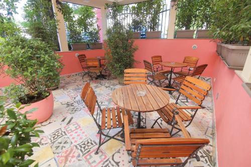 a patio with tables and chairs on a red wall at Boutique Hotel Asteria in Ljubljana