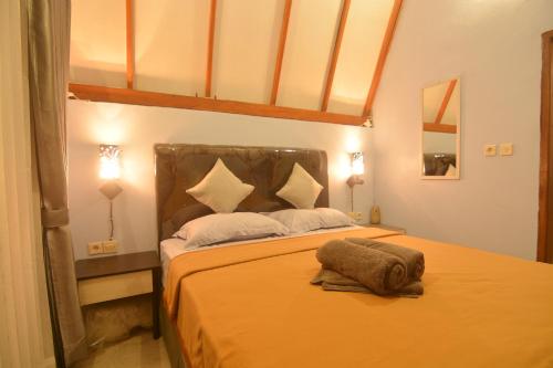 Postel nebo postele na pokoji v ubytování Bale Baleku Homestay