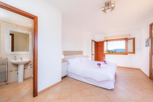 a bedroom with a bed and a sink and a mirror at Can Bosco in Son Servera