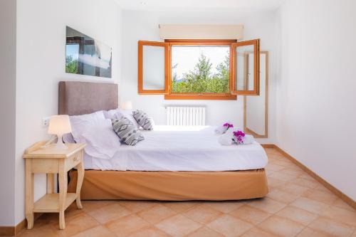 a bedroom with a bed and a window at Can Bosco in Son Servera