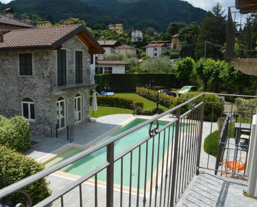 a view from the balcony of a house with a swimming pool at Bellagio Love apartment Pool Near lake Free parking in Bellagio