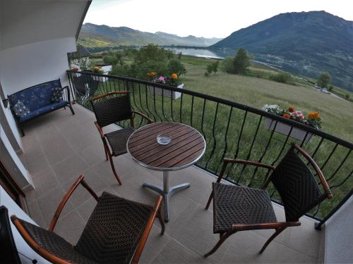 a balcony with a table and chairs and a view at Guest House Blue Views in Plav