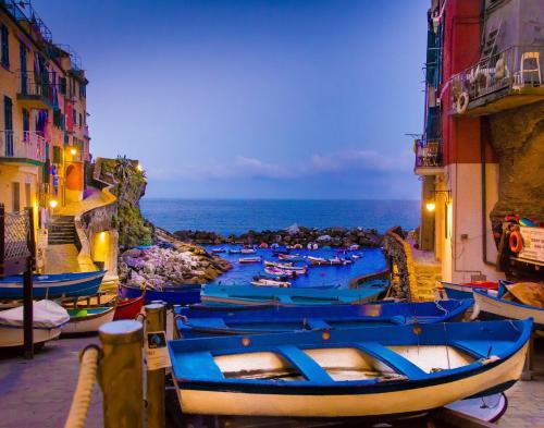 a group of boats are lined up on a street at Una Finestra sul Mare - Free Wi -Fi in Riomaggiore