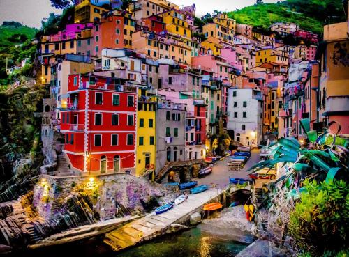 a group of buildings on a hill next to a river at Una Finestra sul Mare - Free Wi -Fi in Riomaggiore