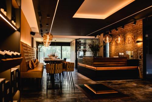 a restaurant with a bar with a table and chairs at Weingut und Gästehaus Zilliken in Nittel