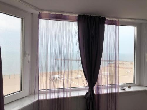 a room with a window with a view of the ocean at Apartament Faleza Nord 3 in Constanţa